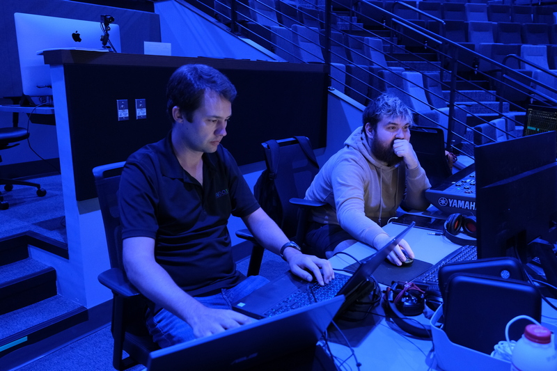 Two people sitting at a video audio station Two people sitting at a video audio station
