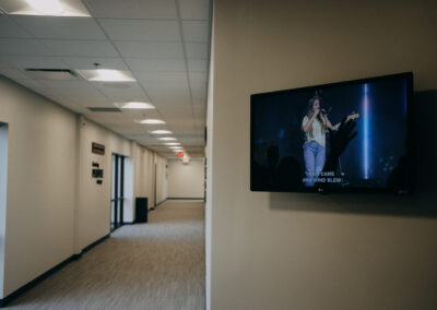 Hallway TV display at Abundant Life Johnson County showing upcoming church events